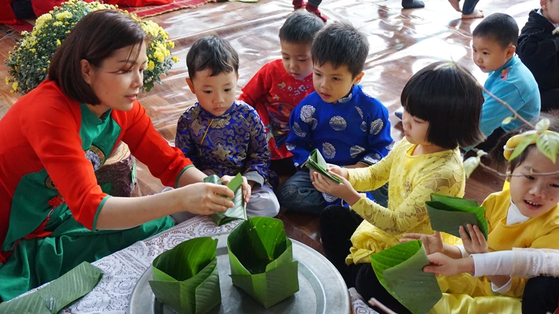 Học sinh học gói bánh chưng ngày Tết. Ảnh minh họa