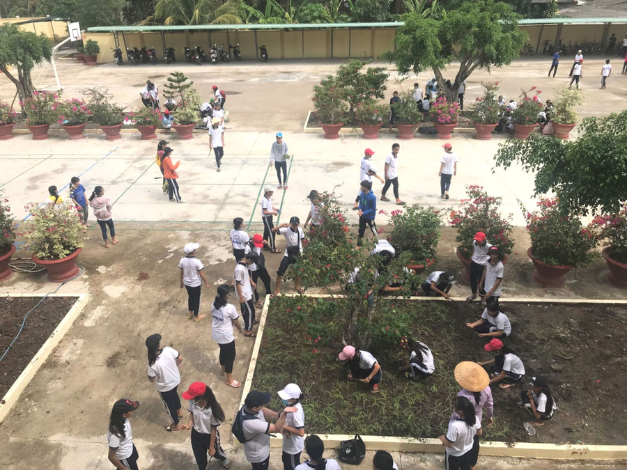 Học sinh Trường THCS Bình Phục Nhứt (huyện Chợ Gạo, Tiền Giang) trồng hoa trong sân trường. Ảnh: NTCC