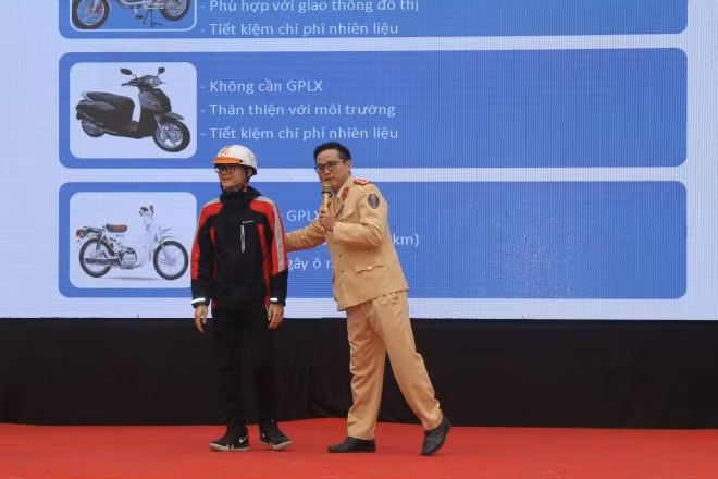 Cán bộ Đội Tuyên truyền và xử lý hướng dẫn học sinh cách đội mũ bảo hiểm Cán bộ Đội Tuyên truyền và xử lý hướng dẫn học sinh cách đội mũ bảo hiểm