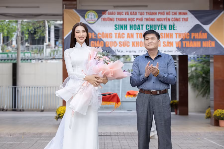 Hoa hậu Thùy Tiên nhận bó hoa tươi thắm từ thầy Phan Hồ Hải, Hiệu trưởng Trường THPT Nguyễn Công Trứ.