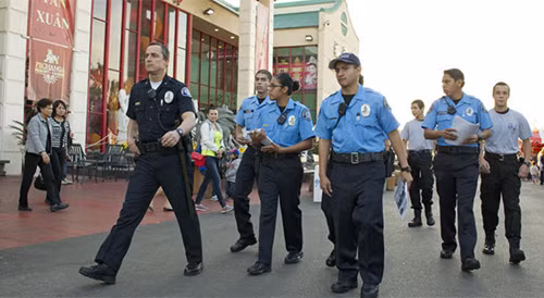 [Caption]Cmdr. Al Panella, left, accompanies a group of Westminster police Explorers as they hand out fliers about three inmates who escaped from an Orange County jail recently. (Kevin Chang / Weekend)