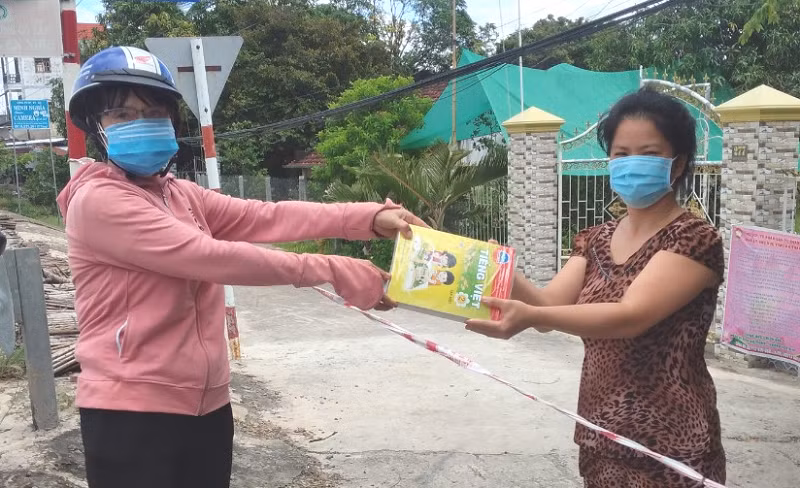Thầy cô giáo ở tỉnh Đồng Tháp trao tặng SGK cho học sinh tại vùng phong tỏa khi dịch Covid-19 còn phức tạp.