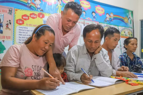 Thầy giáo tận tình hướng dẫn các học viên luyện viết. (Ảnh: Phạm Tâm)