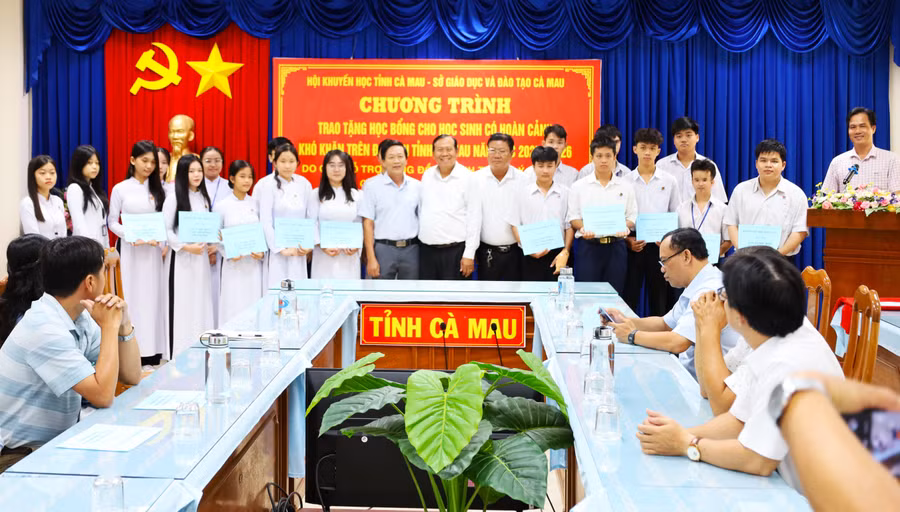 Học sinh được trao tặng học bổng chụp ảnh cùng đại biểu.