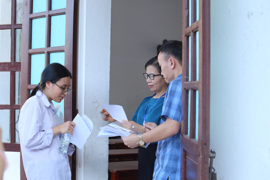 Cán bộ coi thi kiểm tra kỹ các giấy tờ thủ tục và dụng cụ mang theo của thí sinh. 2.jpg