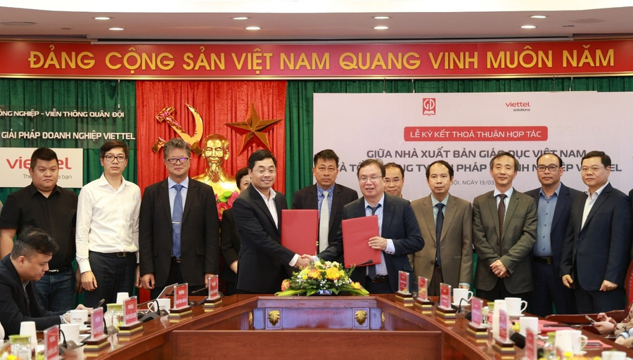 Ông Nguyễn Tiến Thanh - Chủ tịch HĐTV, Tổng giám đốc NXBGDVN và ông Nguyễn Chí Thanh – Phó Tổng Giám đốc Tổng Công ty Giải pháp Doanh nghiệp Viettel trao đổi văn bản thoả thuận hợp tác giữa hai đơn vị. Ảnh: NXBGDVN nxb-6.jpg