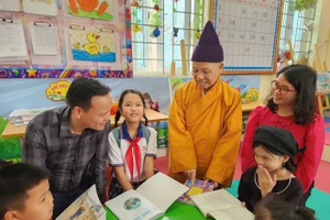 Các em học sinh hào hứng khi có tủ sách mới.