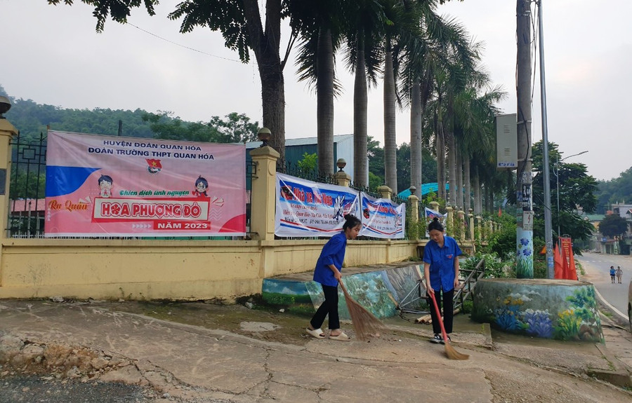 Tình nguyện viên ở Điểm thi Trường THPT Quan Hóa (Thanh Hóa) tham gia quét dọn ở cổng trường. Ảnh: Thế Lượng.