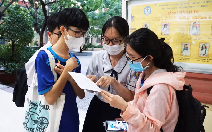 Nhóm thí sinh trao đổi đề tại điểm thi Trường THPT Thủ Thiêm, TP Thủ Đức sau giờ thi Ngoại ngữ. Ảnh: Mạnh Tùng