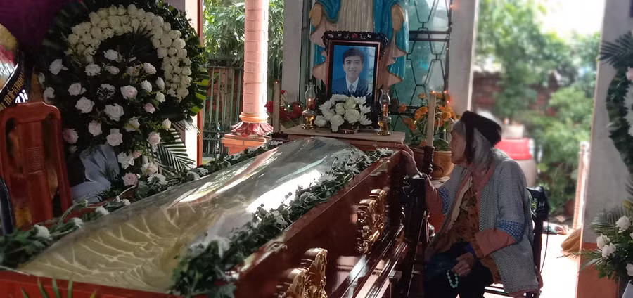 Bà nội của Nhã đã 92 tuổi, ngồi xót xa bên linh cữu cháu. Ảnh: Gia đình cung cấp.