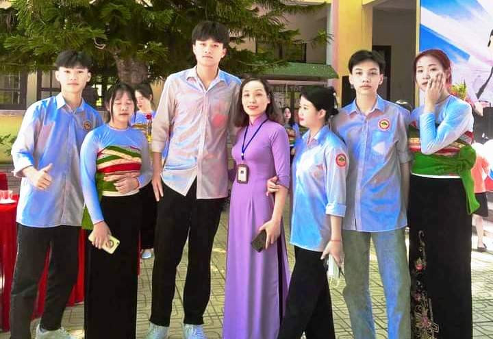 Nam sinh Hà Văn Trung cùng cô giáo chủ nhiệm Hà Thị Hương và các bạn học. Ảnh: NVCC.