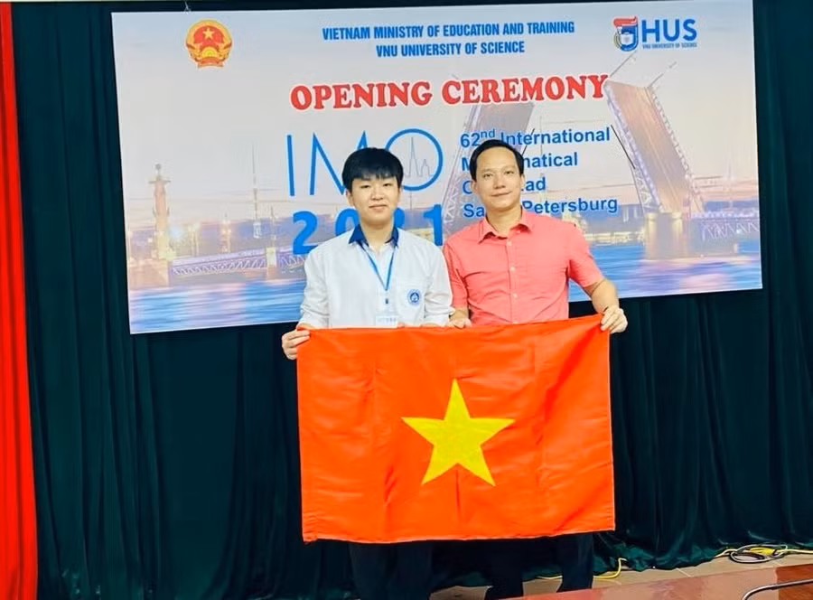 Vũ Ngọc Bình và thầy giáo Lê Xuân Đại (bìa phải) tại lễ khai mạc IMO 2021