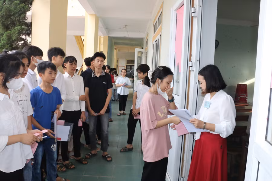 Giám thị kiểm tra thẻ dự thi của thí sinh trường khi vào phòng thi tại Hội đồng thi Trường THPT Nghi Lộc 5, huyện Nghi Lộc, Nghệ An. Ảnh: Hồ Lài.