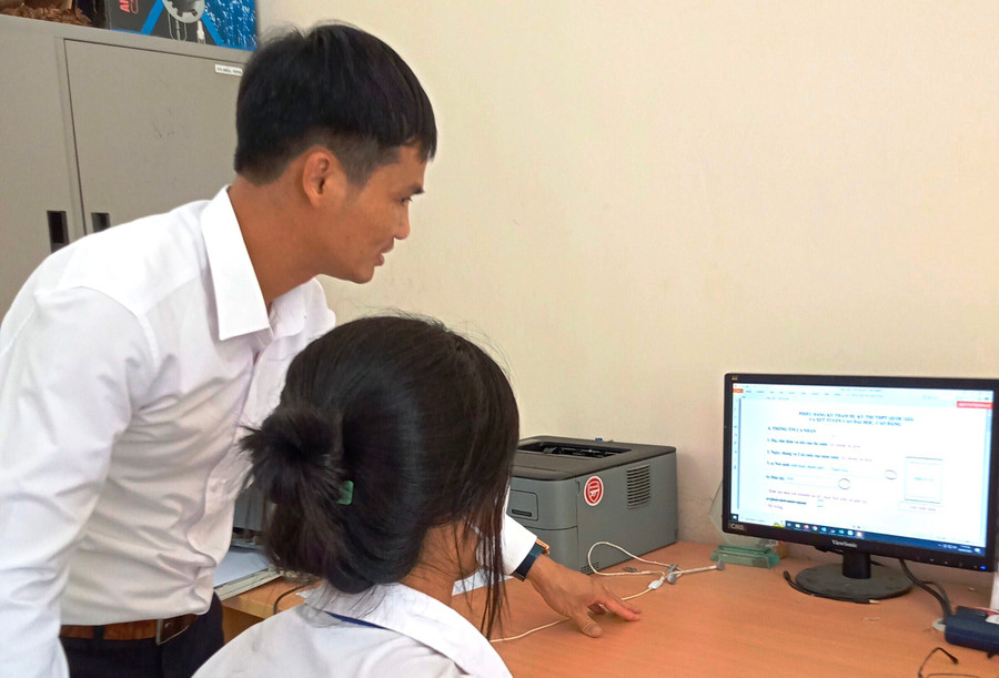 Giáo viên Trường THPT Ngọc Lặc (Thanh Hóa) hướng dẫn học sinh ĐKDT tốt nghiệp. Ảnh: TL. Giáo viên Trường THPT Ngọc Lặc (Thanh Hóa) hướng dẫn học sinh ĐKDT tốt nghiệp. Ảnh: TL.