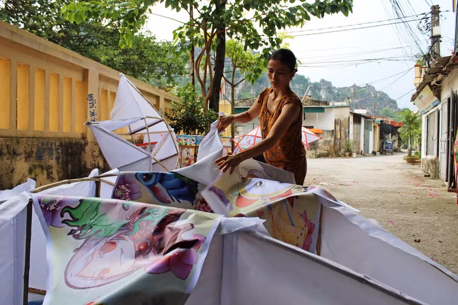 Hoàn thành việc tạo khung, người thợ sẽ bắn đinh cố định vải và bạt quanh khung tre. Công đoạn này khó nhất, bởi nếu bạt bị trùng sẽ khiến chiếc đèn trở nên nhăn nhúm, không đẹp mắt.