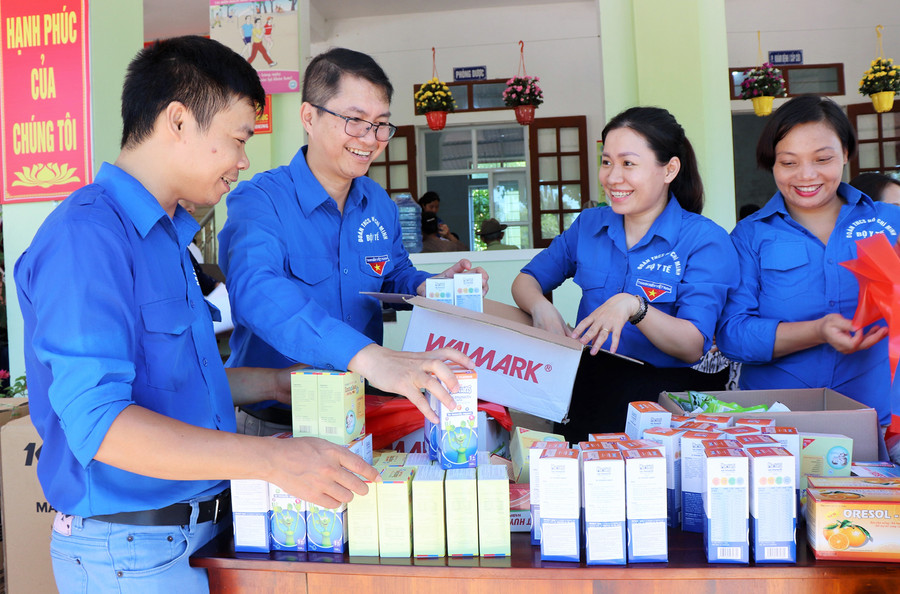 Đoàn thanh niên tình nguyện đang chia quà tặng cho người dân. Đoàn thanh niên tình nguyện đang chia quà tặng cho người dân.