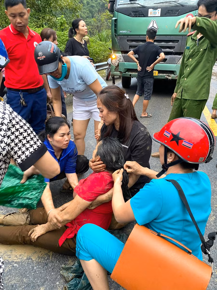 Nhiều người dân, lực lượng cứu hộ đưa cô giáo gặp nạn ra khỏi đất đá vùi lấp. Ảnh: NTCC.