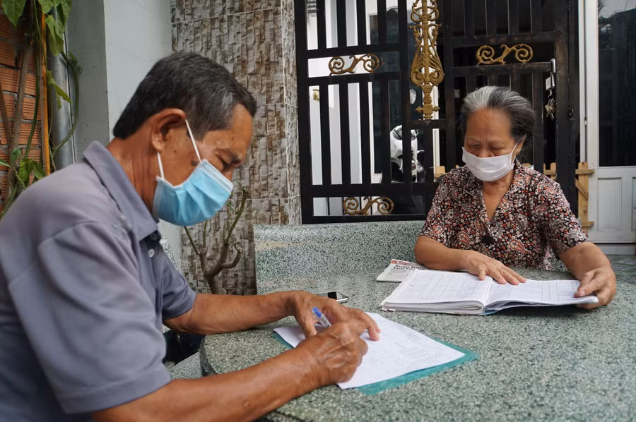 Cán bộ khu phố ở TP Thủ Đức thống kê người lao động bị ảnh hưởng bởi Covid-19 để nhận gói hỗ trợ. Ảnh: Lê Nam