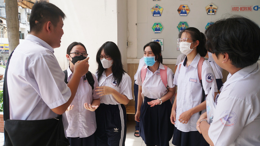 Thí sinh trao đổi trước giờ thi môn Ngoại ngữ tại điểm thi Trường THCS Trần Văn Ơn, quận 1, TPHCM. Ảnh: Lê Nam