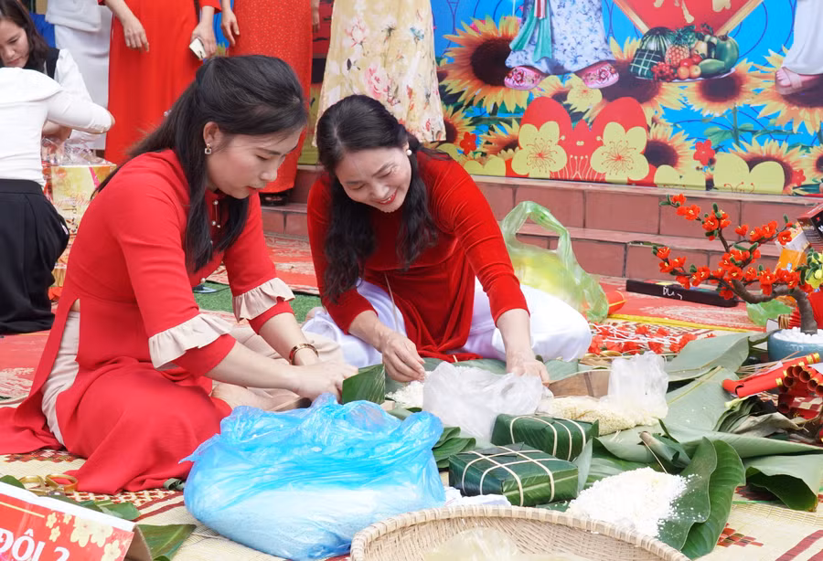 Giáo viên các trường tham gia thi gói bánh chưng, bánh tét tại chương trình tết sum vầy. Ảnh: Hồ Lài