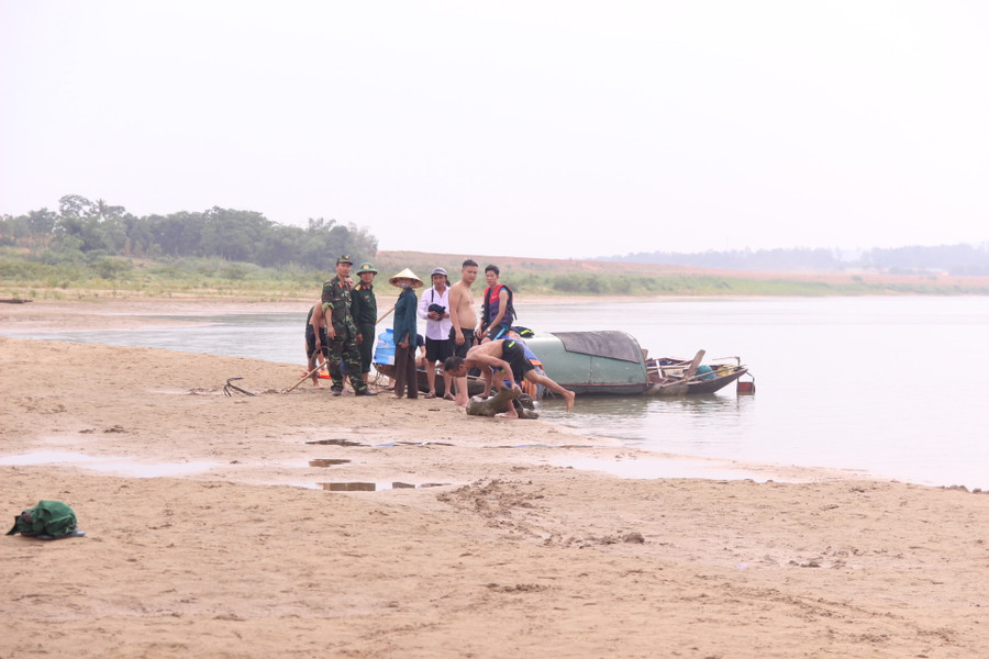Thợ lặn chuẩn bị dụng cụ để lặn tìm kiếm học sinh mất tích dưới sông Lam
