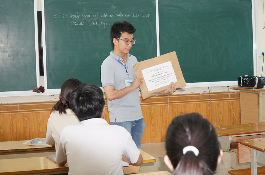 Giám thị giới thiệu và kiểm tra niêm phong túi đựng đề thi. Ảnh: Hồ Lài Giám thị giới thiệu và kiểm tra niêm phong túi đựng đề thi. Ảnh: Hồ Lài