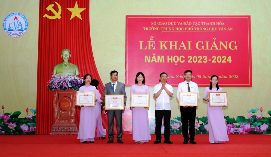 Ông Lê Văn Tú, Chủ tịch UBND TP Sầm Sơn (đứng giữa) dự Lễ khai giảng năm học 2023-2024 và trao thưởng các thầy, cô giáo Trường THPT Chu Văn An. Ảnh: NTCC.