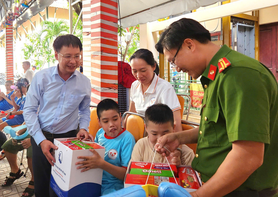 Ông Nguyễn Ngọc Toản (Giám đốc Trung tâm Điều dưỡng, Phục hồi chức năng - Trợ giúp trẻ em và Hỗ trợ người khuyết tật) cùng đại biểu trao quà cho các em nhỏ tham dự. Ảnh: L.N z7088082180848-dc98a44d48c2cbae168f74543c214a06.jpg