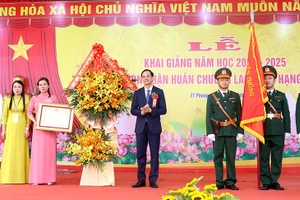 Ông Nguyễn Hải - Chủ tịch Ủy ban MTTQ tỉnh Phú Thọ trao Huân chương Lao động hạng Nhì và tặng lẵng hoa tươi thắm chúc mừng thầy và trò Trường THCS Giấy Phong Châu.