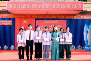 Bà Đào Thị Bích Ngọc - Phó Bí thư Thường trực Đảng ủy xã Bản Nguyên và ông Cao Xuân Hoạt - Hiệu trưởng Trường THCS Bản Nguyên trao thưởng cho học sinh. 