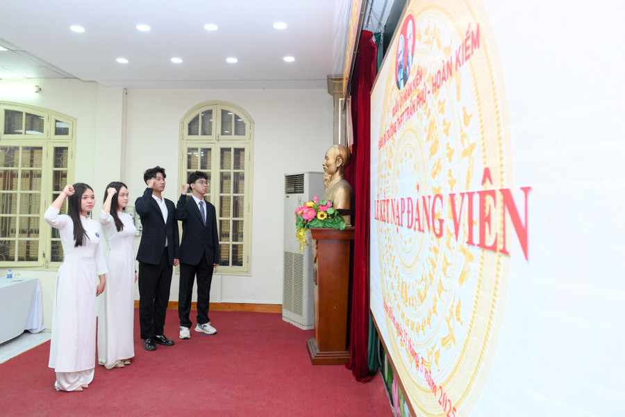 Bốn Đảng viên mới đọc lời tuyên thệ trước Quốc kỳ, Đảng kỳ, chân dung Chủ tịch Hồ Chí Minh.