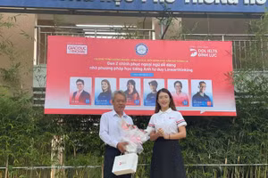 Diễn giả Ngọc Anh - đại diện DOL English tặng hoa BGH trường THPT Hồ Thị Bi.