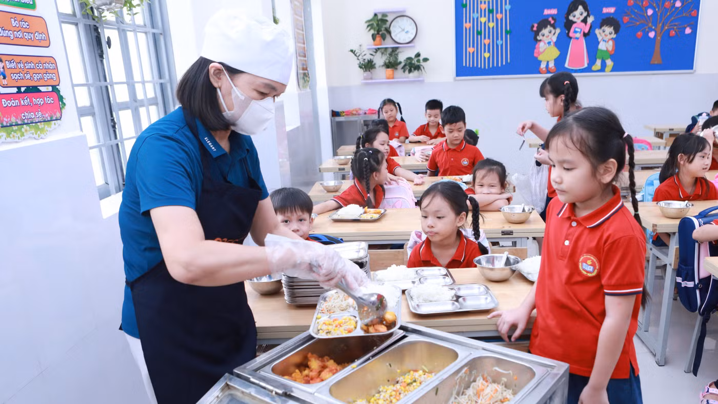 Giờ chia suất ăn bán trú tại Trường Tiểu học Tân Hội, xã Ô Diên, Hà Nội. Ảnh: Đình Tuệ.