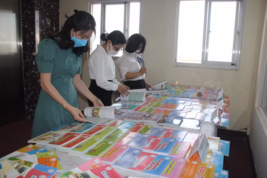 Cán bộ, giáo viên tham khảo SGK lớp 3 tại buổi hội thảo ngày 25/2/2022