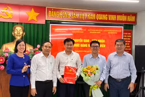 Bà Nguyễn Thị Là, Phó Bí thư Thường trực Đảng ủy Khối Đại học, Cao đẳng TPHCM trao Quyết định tiếp nhận và tặng hoa chúc mừng các đơn vị. Ảnh: Đ.U.K