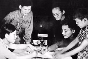 Má Sáu Ngẫu (thứ ba, từ phải sang) cung cấp tấm bản đồ và hướng dẫn đường tiến quân vào Sài Gòn cho chỉ huy Trung đoàn 27. Ảnh: Tư liệu Báo Quân đội Nhân dân.