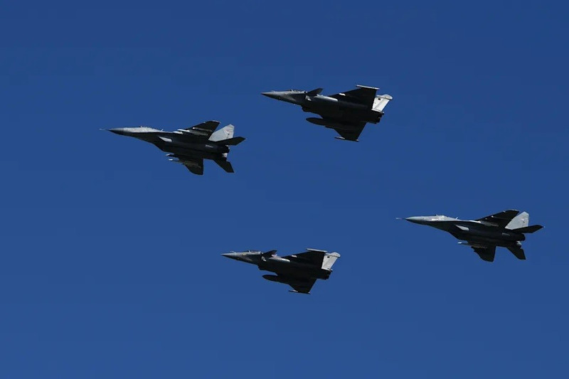 Máy bay MiG-29 của quân đội Serbia, bên trái và bên phải, cùng máy bay chiến đấu Rafale của Không quân Pháp bay trên bầu trời trong một cuộc duyệt binh ở Belgrade, Serbia. (Ảnh AP/Darko Vojinovic) belgrade-ruc-ro-trong-duyet-binh-nhan-ngay-thong-nhat-serbia-2.jpg