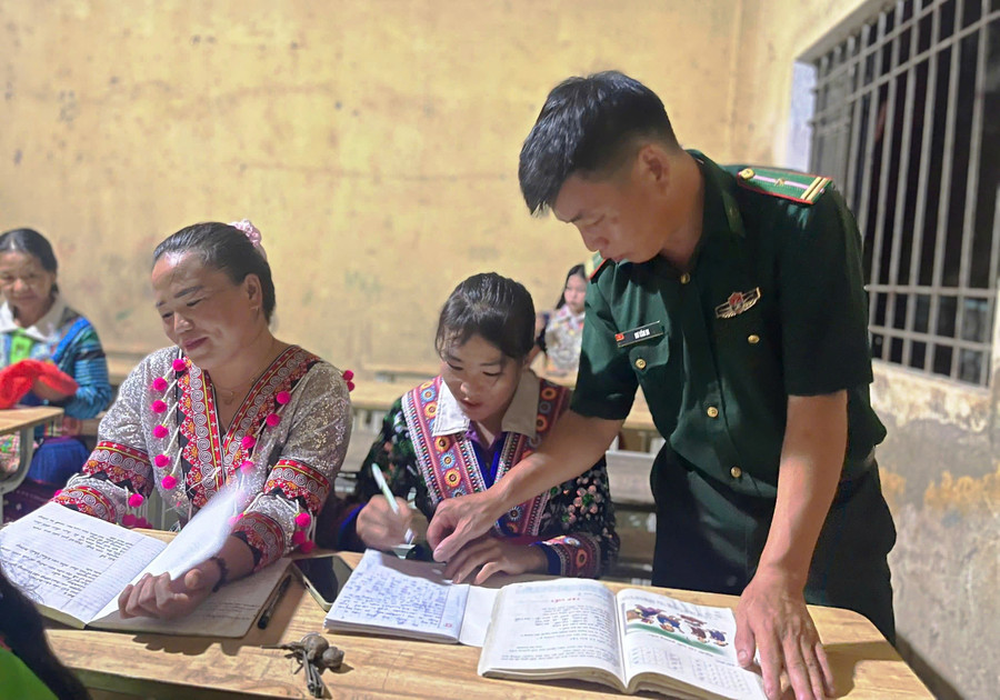 Cán bộ Đồn Biên phòng Trung Lý (Thanh Hóa) dạy chữ cho đồng bào Mông. 
