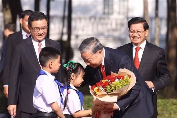 Thiếu nhi Lào tặng hoa, chào mừng Tổng Bí thư Tô Lâm thăm cấp Nhà nước tới Lào. Ảnh: Thống Nhất/TTXVN
