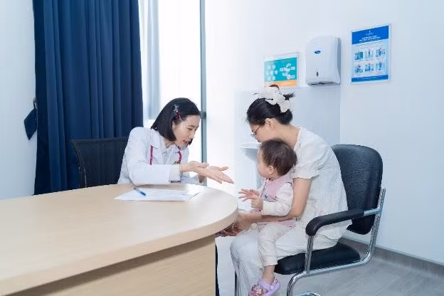 Tại khoa Nhi - Sơ sinh, một bé gái 2 tuổi được ThS.BS Hoàng Thị Mai thăm khám, đánh giá nguy cơ tay chân miệng. Việc thăm khám cho bệnh nhi nhỏ tuổi vốn gặp nhiều khó khăn do trẻ dễ sợ hãi, không hợp tác. Tuy nhiên, với kinh nghiệm chuyên môn cùng sự nhẹ nhàng, tâm lý của đội ngũ bác sĩ, điều dưỡng, bé nhanh chóng ổn định và phối hợp tốt.