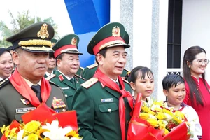 Bộ trưởng Phan Văn Giang và Bộ trưởng Tea Seiha nhận hoa từ thầy, trò Trường Tiểu học Bến Cầu. (Ảnh: H.L)