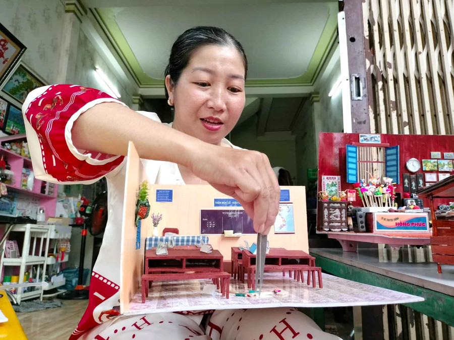 Chị Nguyễn Hồng Phúc đang làm mô hình trường học xưa.