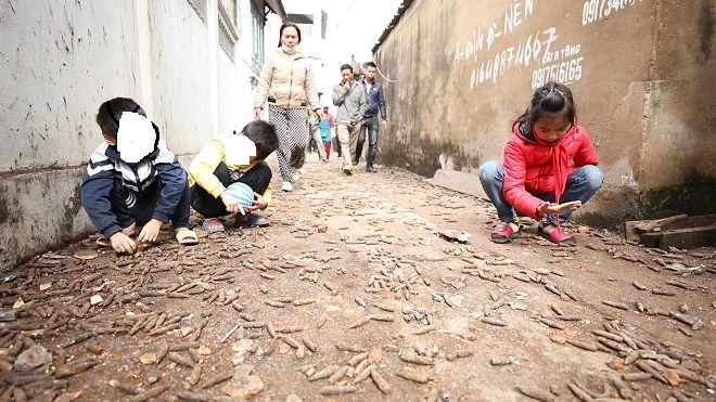 Nhiều trẻ nhỏ vẫn vô tư đùa nghịch, nhặt những xác đạn trên đường mà lực lượng chức năng chưa kịp thu gom