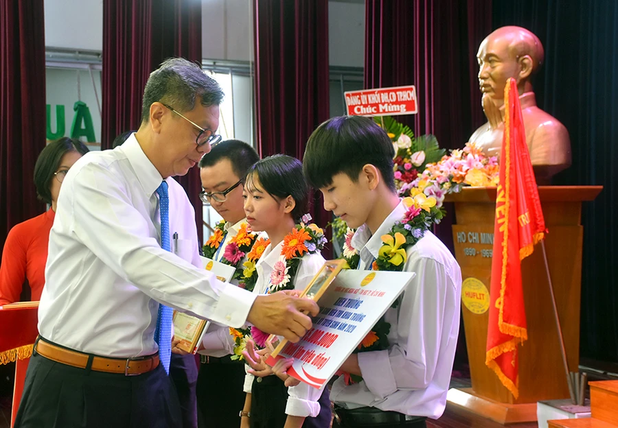 Ông Lưu Đức Hiển - Chủ tịch Hội đồng HUFLIT trao học bổng cho 3 thủ khoa đầu vào của trường.