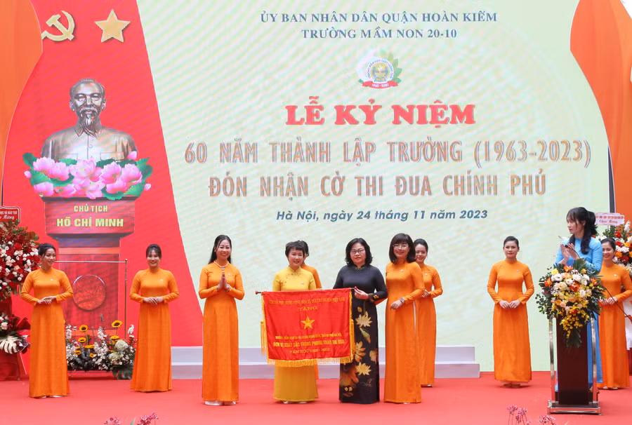 Thứ trưởng Bộ GD&ĐT Ngô Thị Minh trao cờ thi đua của Chính phủ cho tập thể Trường Mầm non 20-10.