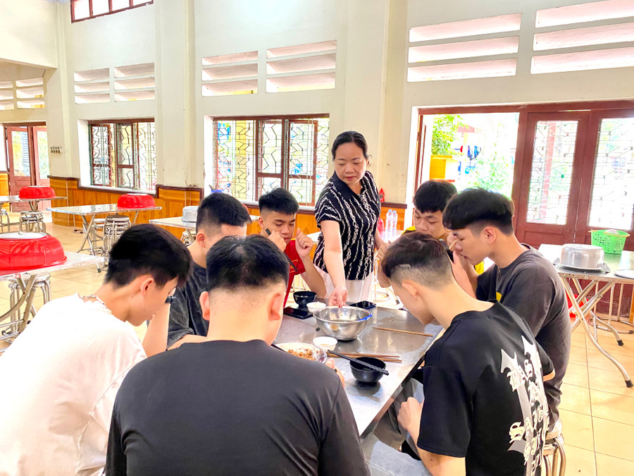 Cô Lương Ngọc Thanh – Phó hiệu trưởng Trường THPT DTNT tỉnh Lạng Sơn động viên học sinh tại bữa ăn. Ảnh Ngô Chuyên.