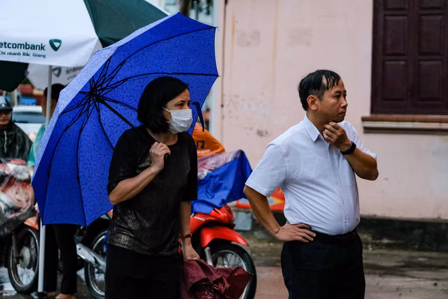 Sau khi thí sinh vào Điểm thi, phụ huyunh ngóng theo với mong mỏi thí sinh sẽ làm bài thi tốt.