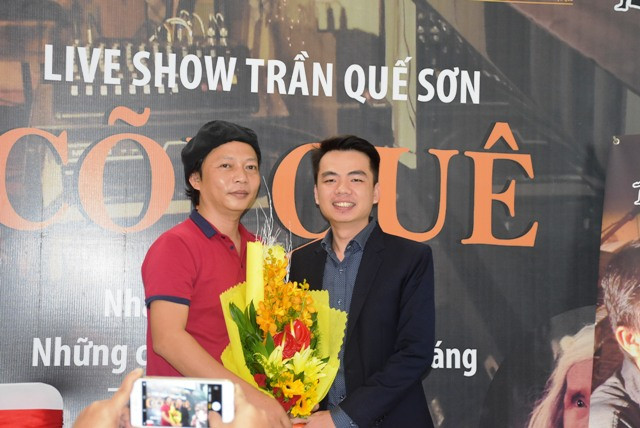 Đại diện đơn vị hỗ trợ tặng hoa chúc mừng nhac sĩ Trần Quế Sơn