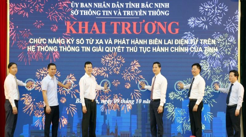 Ông Vương Quốc Tuấn, Phó Chủ tịch Thường trực UBND tỉnh Bắc Ninh (đứng thứ 3 từ phải qua) cùng các đại biểu bấm nút khai trương chức năng ký số từ xa và phát hành biên lai điện tử.