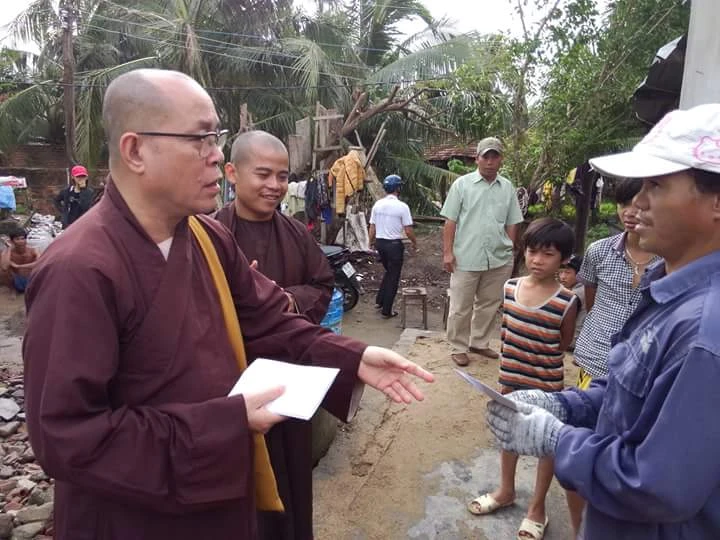 Thượng tọa Thích Đạt Đức trao tiền hỗ trợ cho các gia đình tại huyện Vạn Ninh